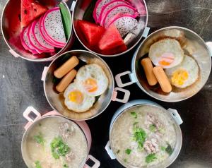 a group of bowls of food with eggs and fruit at Utopua Resort ยูโทปัวว์ รีสอร์ท in Pua