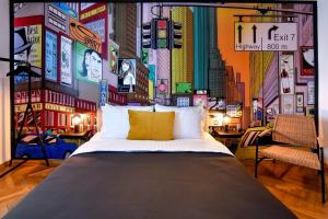 a bedroom with a large bed in a city at Colorful Chic: Cozy Studio in the Bustling City Center in Bucharest