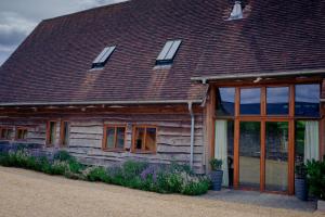 a wooden house with windows and a roof at Sabine Barn B&B in Oxford