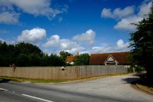 a house with a fence on the side of the road at Sabine Barn in Oxford