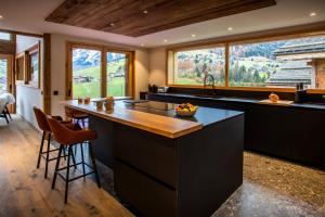 a kitchen with a large island with a counter top at Chalet Fernand - OVO Network in La Clusaz