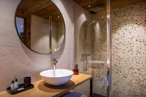 a bathroom with a bowl sink and a shower at Chalet Fernand - OVO Network in La Clusaz