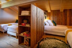 a bedroom with two beds in a room at Chalet Fernand - OVO Network in La Clusaz