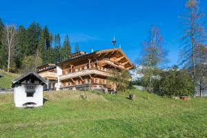 a large wooden house on top of a hill at Wald am See in Kitzbühel