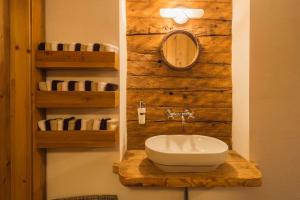 a bathroom with a sink and a mirror and towels at Wald am See in Kitzbühel