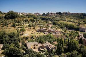 eine Luftansicht eines Dorfes mit Häusern und Bäumen in der Unterkunft Il Leccio Country House in Siena
