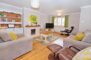 a living room with a couch and a fireplace at 18 Marriotts Way in Sheringham