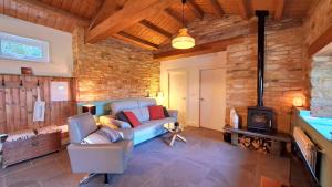 a living room with a couch and a fireplace at Galician Rural Accommodation - La Casita in Lugo