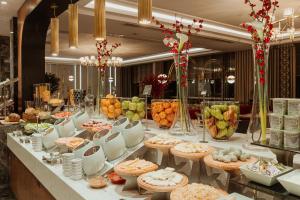 un buffet composé de assiettes et de bols de nourriture dans l'établissement Sheraton Bishkek, à Bishkek