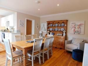 a kitchen and dining room with a wooden table and chairs at Paddlestop House in Sheringham