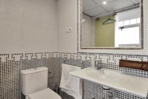 a bathroom with a toilet and a sink and a mirror at GAV La Ermita in Ronda +35 photos