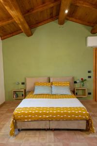 a large bed in a room with wooden ceilings at Casa Vespina Agriturismo Biologico in Orvieto