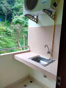 a kitchen with a sink and a window at Pailin Hill Hotel Patong in Patong Beach