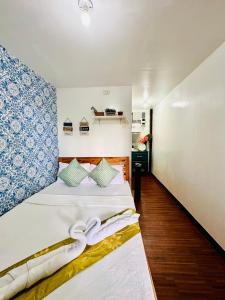 sypialnia z 2 łóżkami i ręcznikami w obiekcie Amancio's Balai - Near the Airport, City Center! w mieście Puerto Princesa