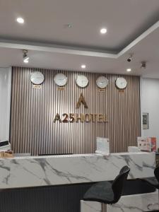 a restaurant with clocks on the wall and a counter at A25 Hotel - 30 An Dương in Hanoi