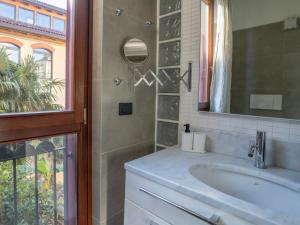 a bathroom with a sink and a mirror at BASTIA RF Suite up to 4 guests - in the heart of Scalo Romana, Olimpico, Prada, Bocconi and easy access Forum Assago, IEO, IED, Duomo, San Siro in Milan
