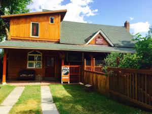 a wooden house with a sign in front of it at Luna Bed & Breakfast in Grand Forks