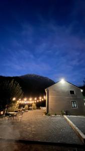 a building with a table and chairs at night at Te baca Qerim in Lekbibaj +79 photos