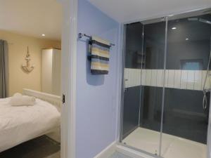 a bathroom with a shower with a glass door at St Christophers Cottage, Sheringham - Keys Holiday Cottages in Sheringham +17 photos