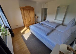 a bedroom with a large bed with blue sheets at Ferienwohnung Ruthenaar in Willingen