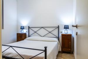 ein Schlafzimmer mit einem großen Bett und zwei Nachttischen in der Unterkunft Vista Mare Blu in Marina di Grosseto