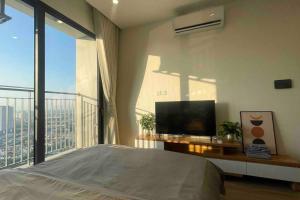 a bedroom with a bed and a tv and a balcony at Vinhomes Smart City - Căn hộ Studio cao cấp tại tòa SA3 in Hanoi