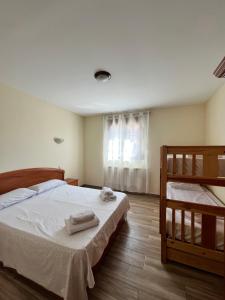 a bedroom with a bed with two towels on it at Finca los Rosales de la Vega in Estremera +22 photos