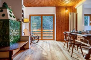 a kitchen with a table and chairs in a room at Villa la Brisa 2 in Predazzo