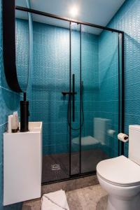 a bathroom with a toilet and a glass shower at Résidence Beaugrenelle - Tour Eiffel 1 in Paris