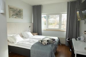 a bedroom with a bed with a pillow on it at Finlandia Hotel Alba in Jyväskylä