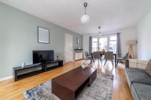 a living room with a couch and a table at The Camden Road Collection in London