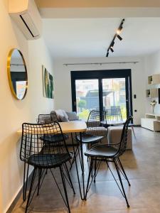 a dining room with a table and chairs at GEMINI VILLAS NIKITI in Nikiti
