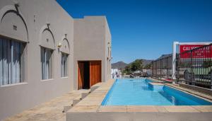 a swimming pool next to a building at Calvinia Hotel in Calvinia