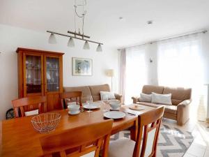 a dining room with a table and a couch at Achtern Diek Whg 07 in Boltenhagen