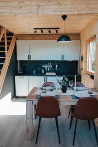 una cocina con una gran mesa de madera y sillas en Lofoten Cabins en Hopen