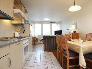 a kitchen and living room with a table and a kitchen and a dining room at Altes Zollhaus, Fewo- Nr 4 in Barendorf