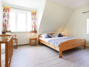 a bedroom with a bed and two windows at Altes Zollhaus, Fewo- Nr 4 in Barendorf +11 photos
