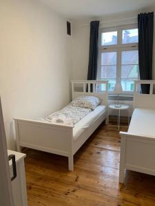 a bedroom with a white bed and a window at 170m2 apartment in Historical building in Gutenzell-Hürbel