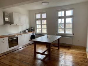 a kitchen with a table in the middle of it at 170m2 apartment in Historical building in Gutenzell-Hürbel