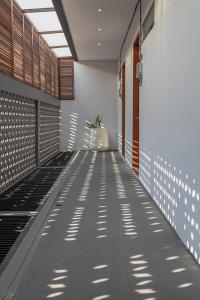 a corridor of a building with a walkway at Forseti Athena in Seminyak