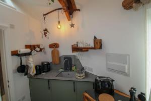 a kitchen with a sink and a counter at The Beehive Warton in Warton