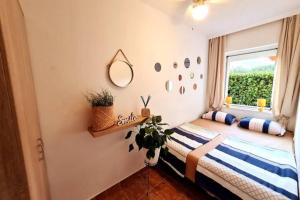 a bed in a room with a window at Seaview Pool Villa with cinema up to 26 in Kaštela
