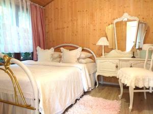 a bedroom with two beds and a mirror and a dresser at Fantazja Letnia in Stegna