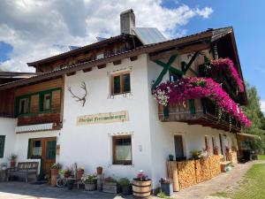 a building with flowers on the side of it at Öfnerhof in Leutasch