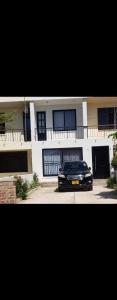 a black car parked in front of a building at Graystone at Oyster Bay in Dar es Salaam