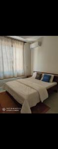a bedroom with two beds and a window at Graystone at Oyster Bay in Dar es Salaam