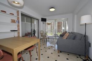 a living room with a couch and a table at Pdo. Mediterráneo - Fincas Arena in Benidorm