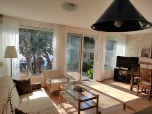 a living room with a couch and a table at Luxury Seaside Holm Oak Villa with Private Beach in Bar