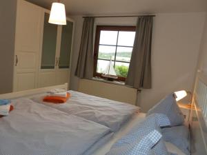 a bedroom with a large bed and a window at Fischerhaus Whg Sommerbrise in Neukloster