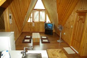 a kitchen with a tv in a wooden cabin at Cabin Liun in Pyeongchang